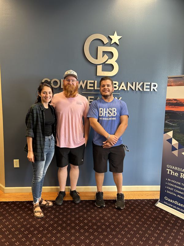Bryce Barnes with couple at Coldwell Banker Realty We Got the Keys