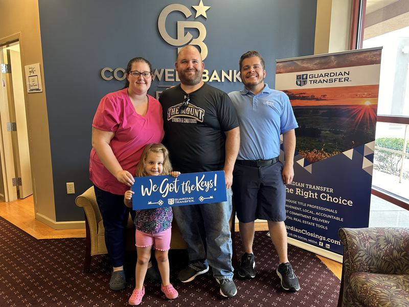 Bryce Barnes with family holding We Got the Keys sign at Coldwell Banker Realty Chambersburg PA